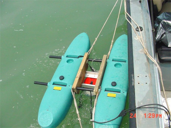 Picture showing pontoon-mounted ADCP tethered to the USGS survey boat.