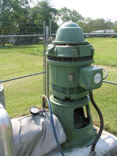 Picture of a pump and plumbing configureation used by public water systems. About 105 million peopleor more than one-third of the Nation's populationreceive their drinking water from one of the 140,000 public water systems across the United States that rely on groundwater pumped from public wells. Photographer: Roland Tollett, USGS